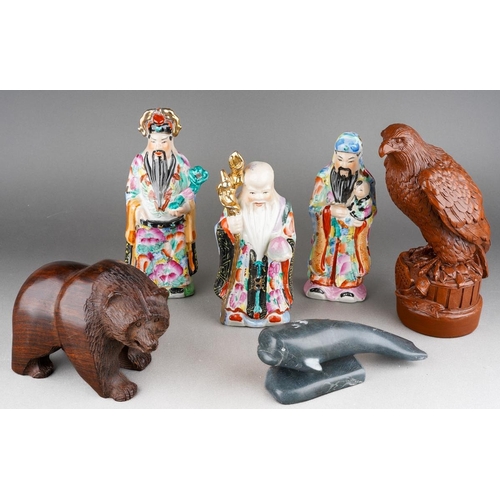 101 - A mixed collectors lot to include a resin model of an American eagle, carved wod bear, Canadial Levi... 