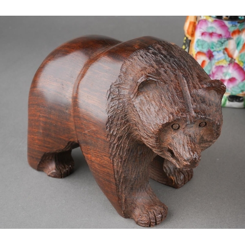 101 - A mixed collectors lot to include a resin model of an American eagle, carved wod bear, Canadial Levi... 