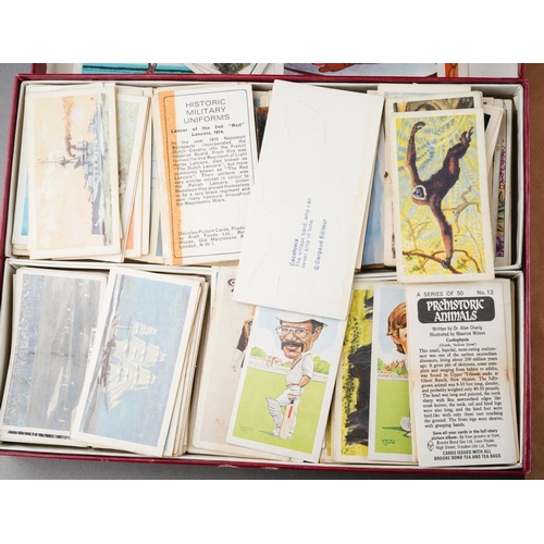 143 - A collection of World stamp, cigarette cards and trade cards, in albums and loose, including The Tri... 
