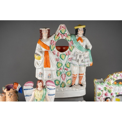 357 - A collection of nine Victorian Staffordshire pottery figures, comprising a figure of a Turk with pit... 