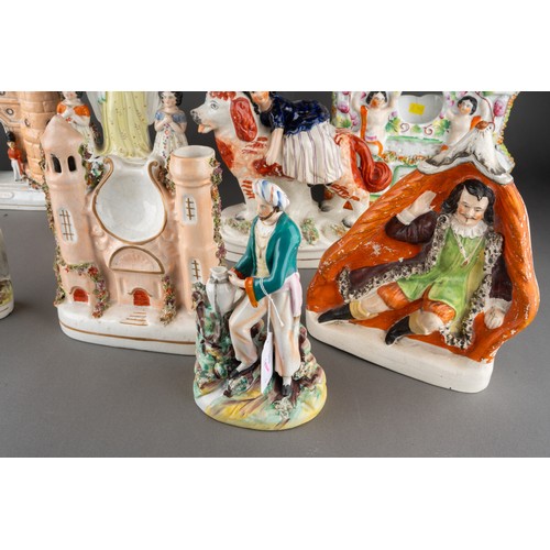 357 - A collection of nine Victorian Staffordshire pottery figures, comprising a figure of a Turk with pit... 