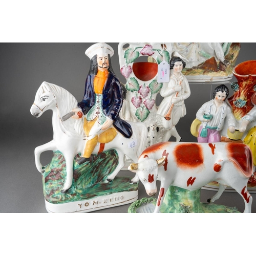 358 - A collection of seven Victorian Staffordshire pottery figures, comprising a cow by a stream (restore... 