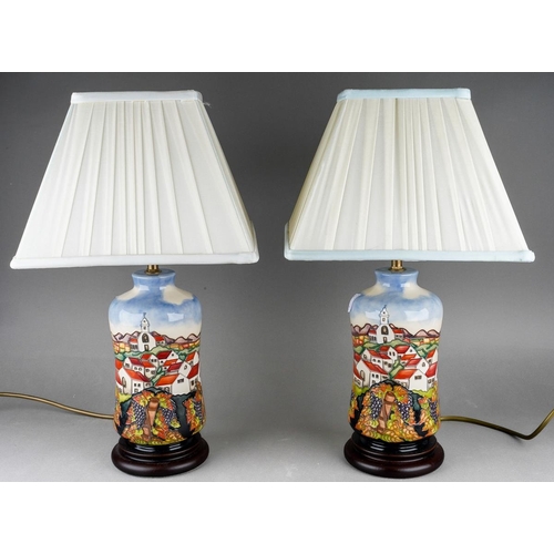 566 - A  pair of tube line decorated table lamps with shades in the style of moorcroft, each approx. 32 cm... 
