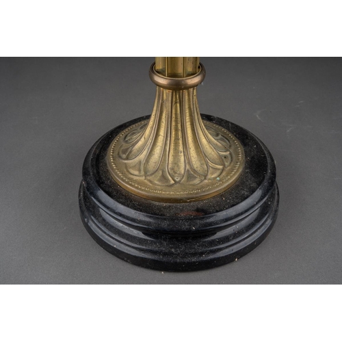 569 - An early 20th century brass based oil lamp, the white glass domed shade with frilled top, comes with... 