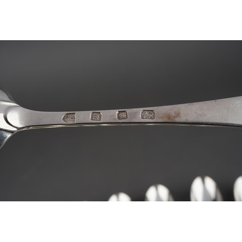 624 - A set of eleven Hanoverian Pattern silver dessert spoons, each engraved with a crest, by Tessiers Lt... 
