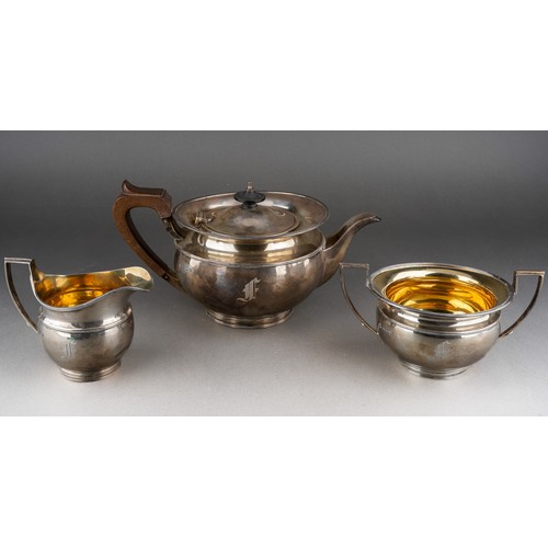 628 - A George V silver teaset comprising teapot with fruitwood handle and finial, milk jug and sugar bowl... 