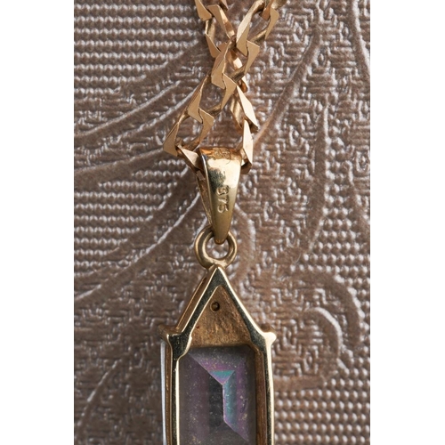 785 - A 9ct gold topaz and diamond pendant with chain. The coated topaz with diamond accent detail, hallma... 