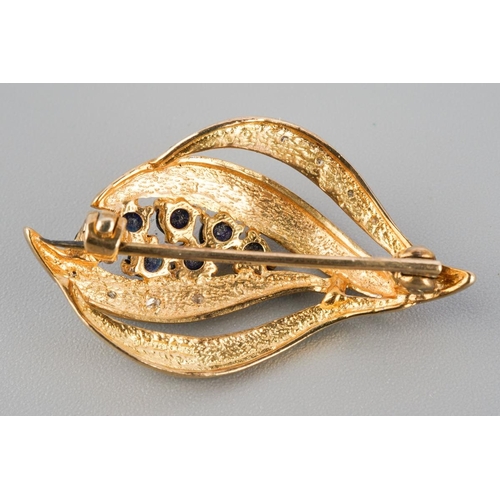 788 - A 9ct gold sapphire and diamond brooch. Hallmarked 9ct gold, approx length 30mm, appprox gross weigh... 