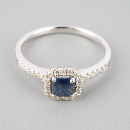 792 - An 18ct gold sapphire and diamond cluster ring. Hallmarked 18ct gold, sponsors mark Beaverbrooks, wi... 
