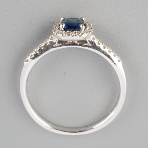 792 - An 18ct gold sapphire and diamond cluster ring. Hallmarked 18ct gold, sponsors mark Beaverbrooks, wi... 