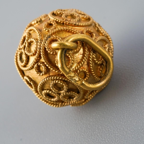 800 - A charm. With cannetille detail, stamped k22, approx diameter approx gross weight 3.9 grams.