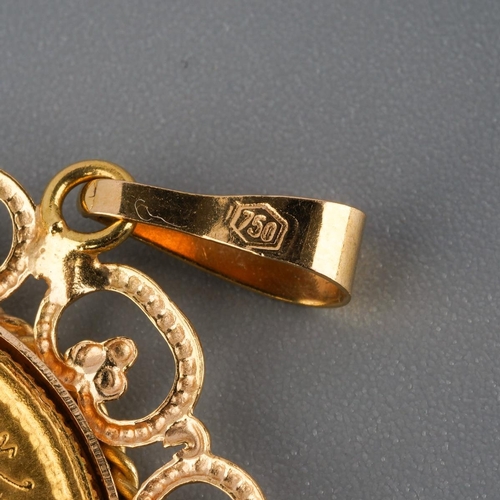 816 - A pendant, stamped 750. The central token, within a scrolling border, stamped 750, approx diameter 3... 