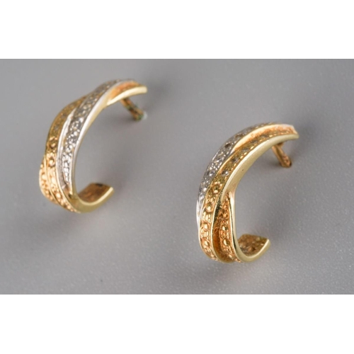828 - A pair of diamond earrings. Each yellow and white cross over design ear hoop set with single cut dia... 