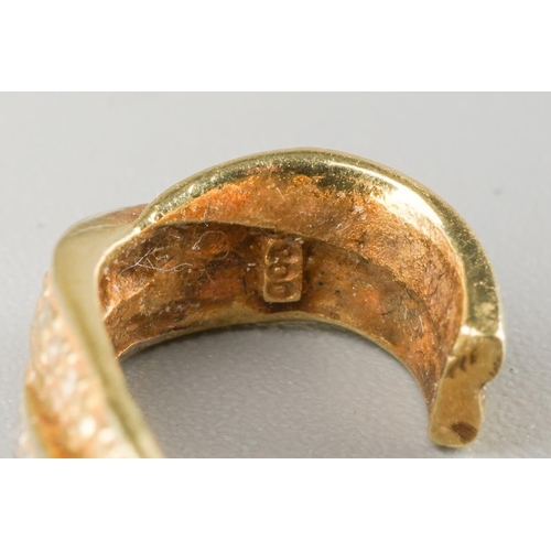 828 - A pair of diamond earrings. Each yellow and white cross over design ear hoop set with single cut dia... 