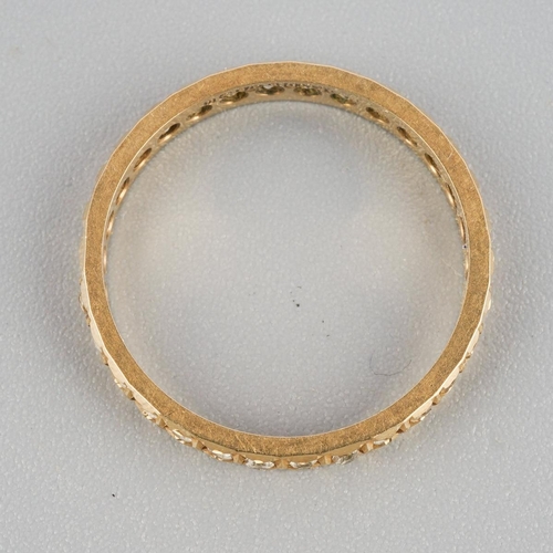 869 - A 9ct gold eternity ring. Set with synthetic white spinel, hallmarked 9ct gold, approx ring size N, ... 