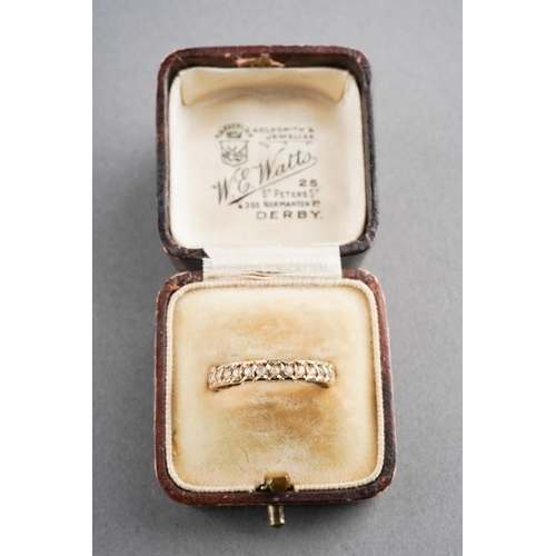 869 - A 9ct gold eternity ring. Set with synthetic white spinel, hallmarked 9ct gold, approx ring size N, ... 