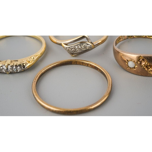 874 - A selection of four gold and diamond set gold rings. To include a 22ct gold wedding band (hallmakred... 