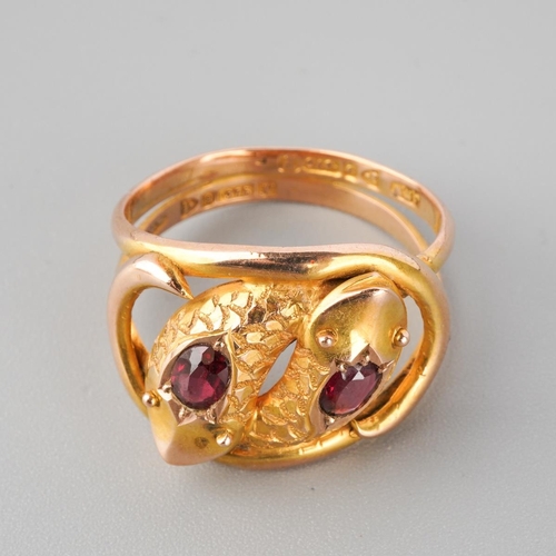 885 - An early 20th century 9ct gold garnet double snake head ring. Hallmarked 9ct gold Chester 1910, appr... 