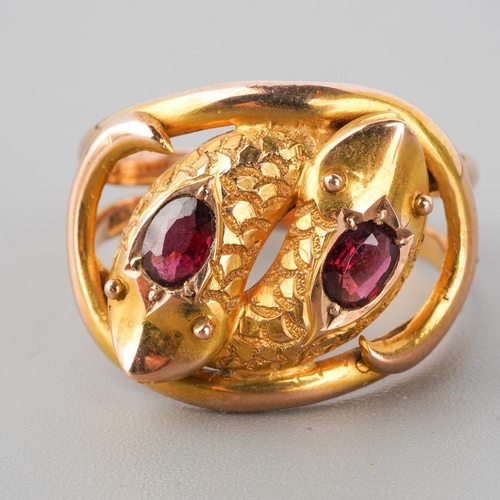 885 - An early 20th century 9ct gold garnet double snake head ring. Hallmarked 9ct gold Chester 1910, appr... 