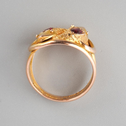885 - An early 20th century 9ct gold garnet double snake head ring. Hallmarked 9ct gold Chester 1910, appr... 