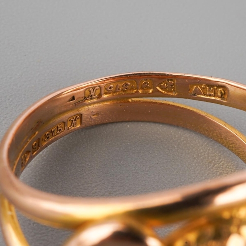 885 - An early 20th century 9ct gold garnet double snake head ring. Hallmarked 9ct gold Chester 1910, appr... 