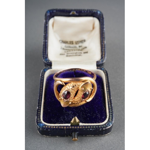 885 - An early 20th century 9ct gold garnet double snake head ring. Hallmarked 9ct gold Chester 1910, appr... 