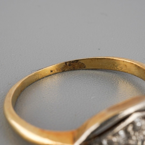 914 - An early 20th century diamond ring. Set with single cut diamonds, stamps worn away, assessed as appr... 