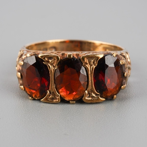 915 - A 9ct gold garnet three stone ring. Hallmarked 9ct gold Dublin, approx ring size L, approx gross wei... 