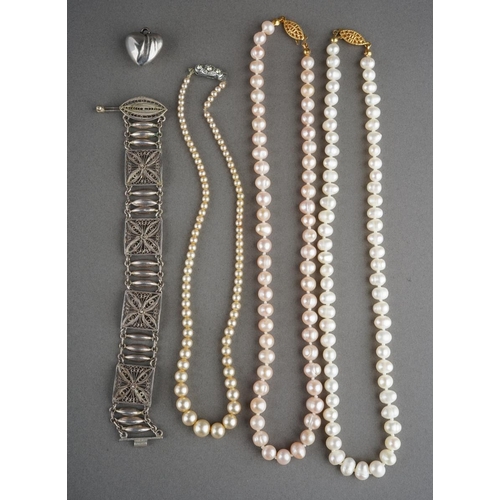 919 - A white metal bracelet (gross weight 17g) and 3 pearl necklaces and a white metal heart pendant