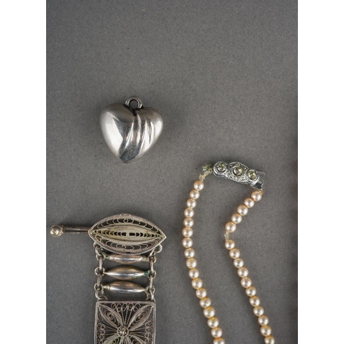 919 - A white metal bracelet (gross weight 17g) and 3 pearl necklaces and a white metal heart pendant
