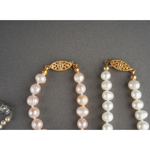 919 - A white metal bracelet (gross weight 17g) and 3 pearl necklaces and a white metal heart pendant