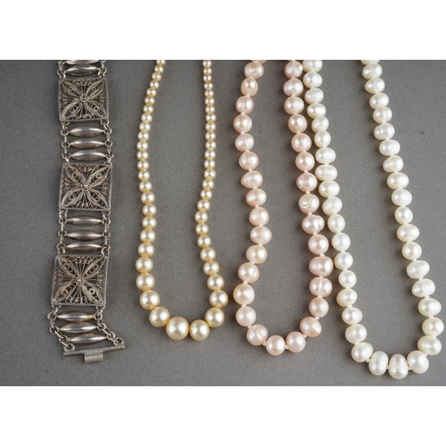 919 - A white metal bracelet (gross weight 17g) and 3 pearl necklaces and a white metal heart pendant