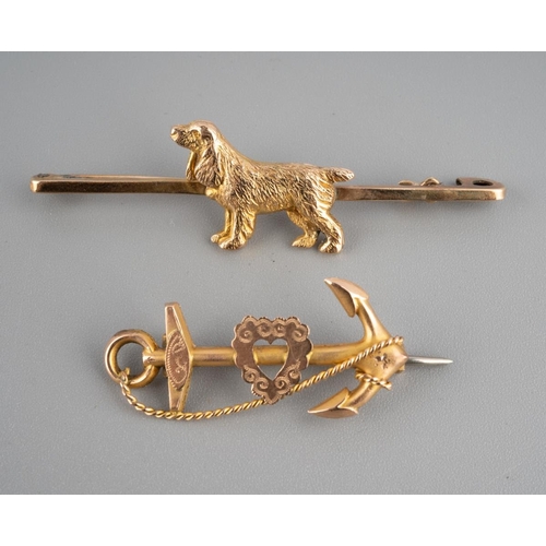 943 - Two 9ct gold brooches to include bar brooch with a spaniel dog marked 9 ct and an anchor sweetheart ... 