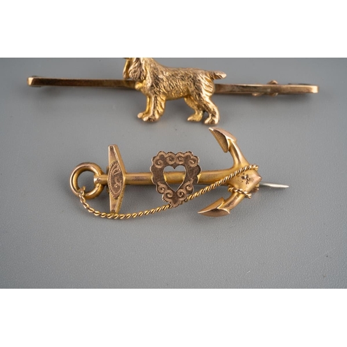 943 - Two 9ct gold brooches to include bar brooch with a spaniel dog marked 9 ct and an anchor sweetheart ... 