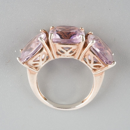 955 - An amethyst three stone ring. Stamped 925 S, approx ring size M, approx gross weight 6.19 grams.