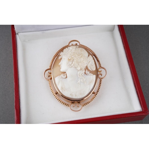 974 - A 9ct cameo brooch brooch. The shell cameo carved to depict a Bacchante stamped 9ct, makers mark W.N... 