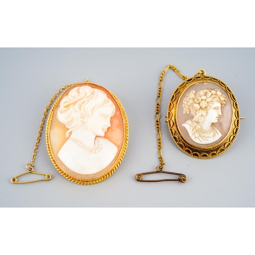 979 - Two cameo brooches. To include a late 19th century shell cameo brooch depicting a Bacchante within a... 