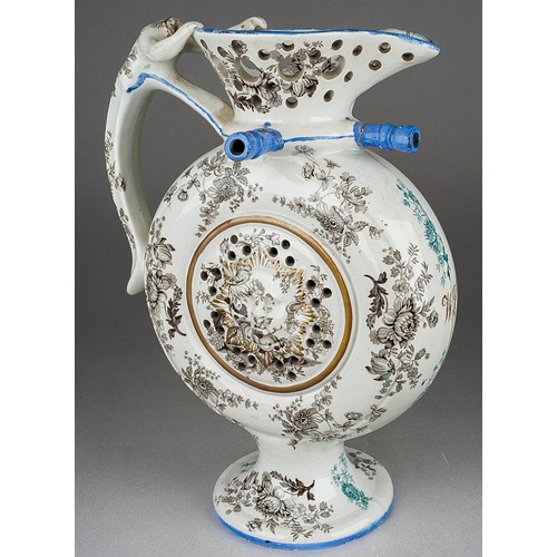 242 - An early 19th Century transfer printed puzzle jug, the circular flask form centred by a raised sun m... 