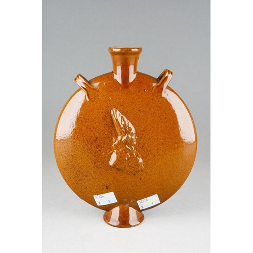 9 - A Stoneware two handled Pilgrim's Flask, body with Medieval Standing figure and Bishops profile in r... 