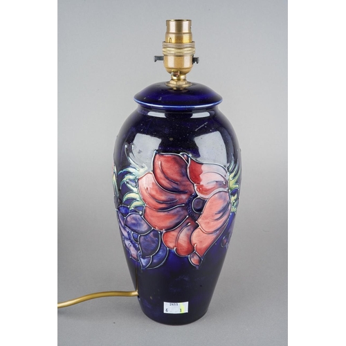31 - A Moorcroft Anemone pattern lamp base on dark blue ground, stamp and painted marks, the entire appro... 