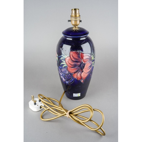 31 - A Moorcroft Anemone pattern lamp base on dark blue ground, stamp and painted marks, the entire appro... 