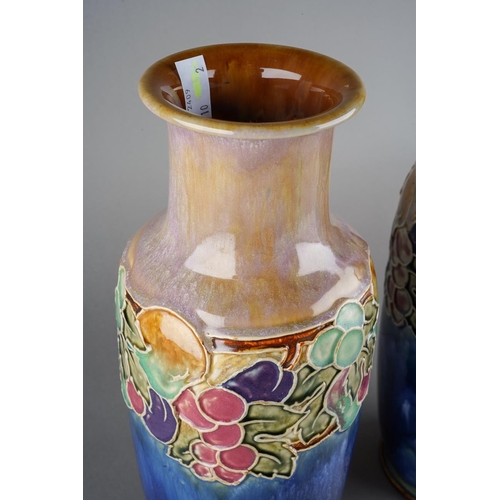 45 - A pair of Doulton Lambeth drip glazed vases, tube lined floral decoration with flowers and fruit, im... 