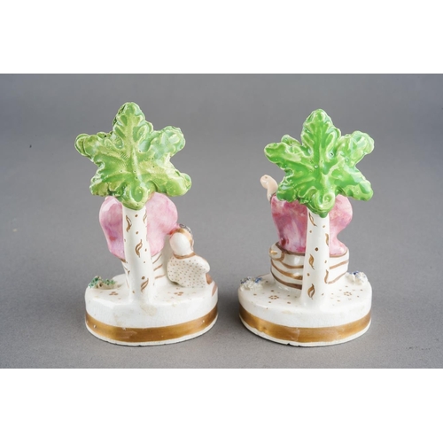 50 - A pair of late 18th Century, possibly Derby, Biblical figures both seated on oval ground with tree a... 