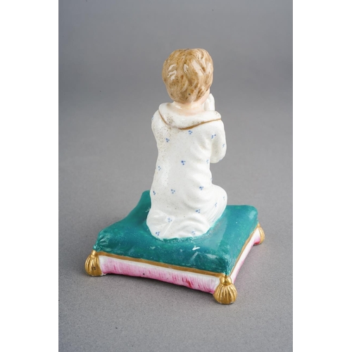 51 - A Derby figure of a boy praying, circa 1795, blue mark, modelled kneeling, on a turquoise cushion wi... 
