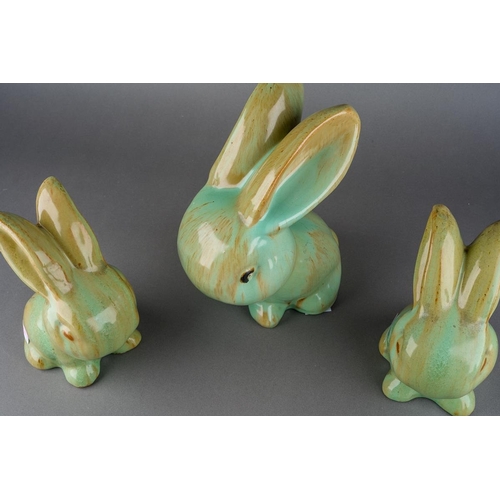 A set of three green glazed rabbits, probably Bourne Denby, the largest ...