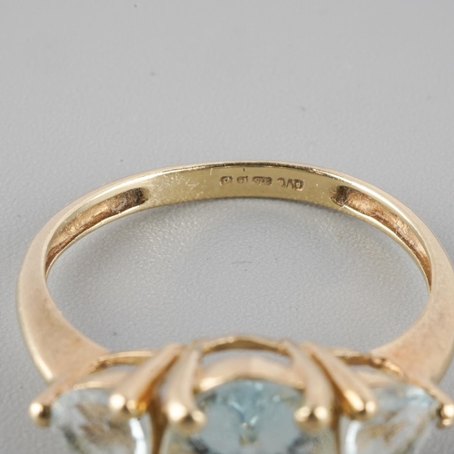 A 9ct gold gem set three stone ring. Hallmarked 9ct gold, sponsors mark ...