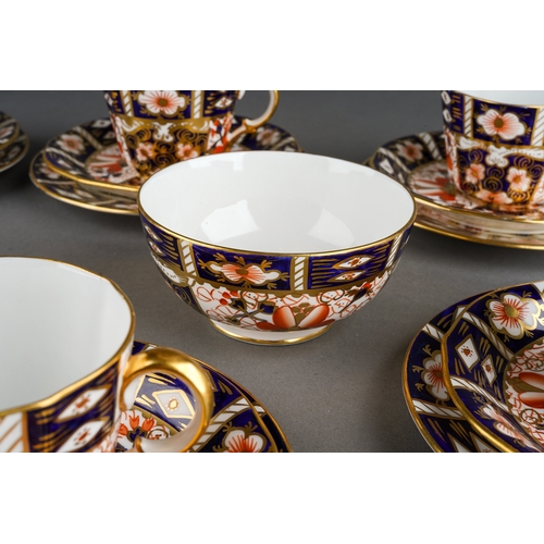 12 - A Royal Crown Derby Imari 2451 pattern nineteen piece tea set, comprising six trios and a sugar bowl... 