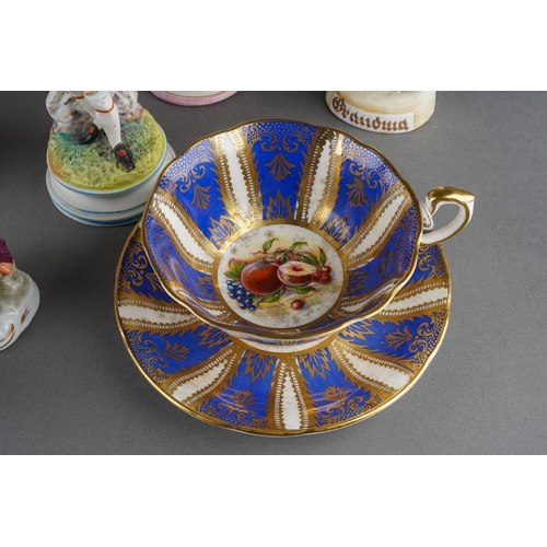 40 - A Paragon China tea cup and saucer, the centres painted with peaches, cherries and grapes within Roy... 