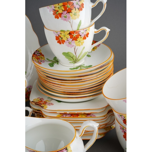 53 - A Grafton China pattern 5459 tea service decorated with primula in various colours comprising cake p... 