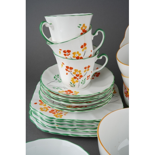 53 - A Grafton China pattern 5459 tea service decorated with primula in various colours comprising cake p... 